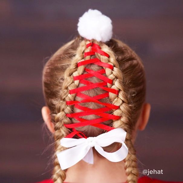 Creative Christmas hairstyle with braided red ribbon and white bow accent.