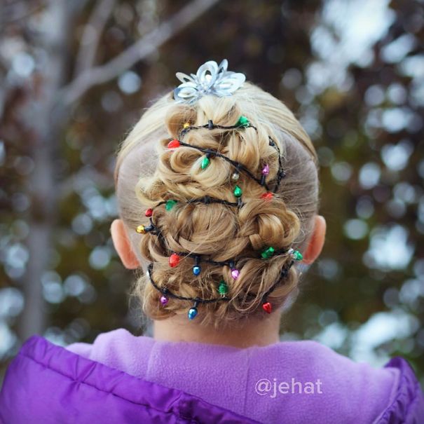 Creative Christmas hairstyle with blonde updo adorned with colorful mini lights and silver hairpin.