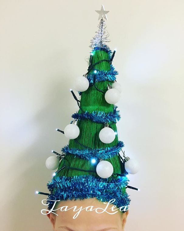 Creative Christmas hairstyle shaped like a decorated tree with ornaments and lights.