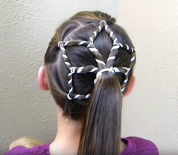 A creative Christmas hairstyle featuring a woven star design on a child's hair with a sleek ponytail.