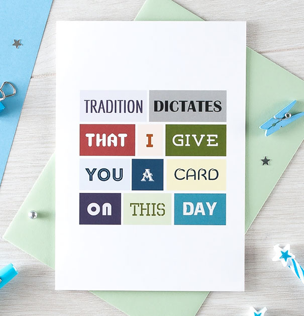 Rude Christmas card on a table with colorful letter blocks spelling a humorous message.