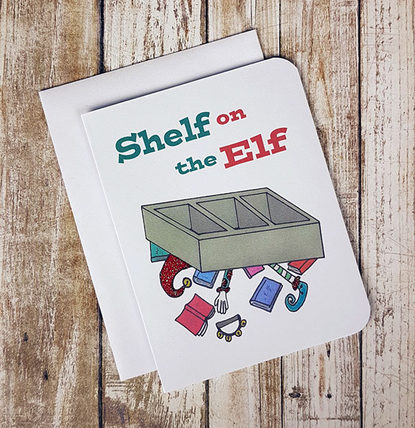 Rude Christmas card with a humorous "Shelf on the Elf" design, featuring an elf trapped under a shelf.