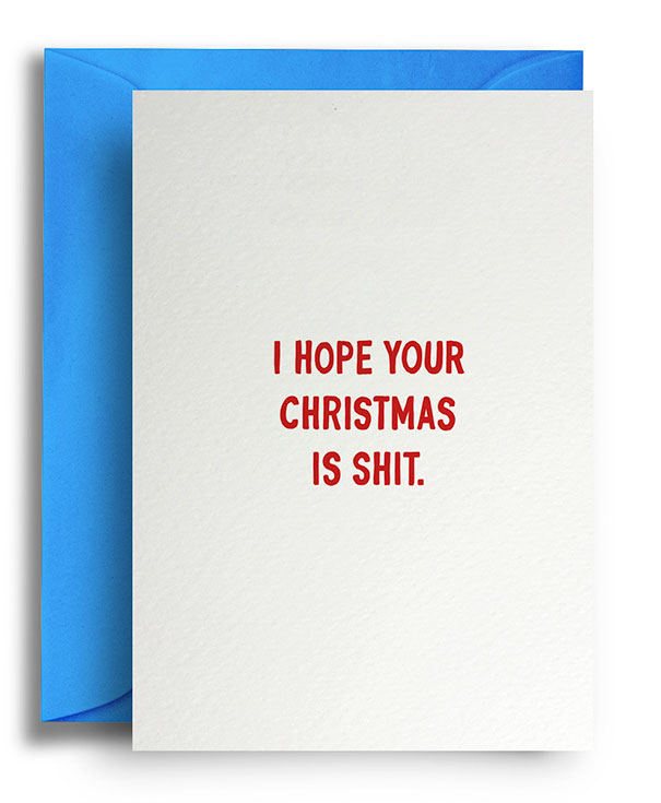 Rude Christmas card with red text reading "I hope your Christmas is s**t" on a white card with blue envelope.