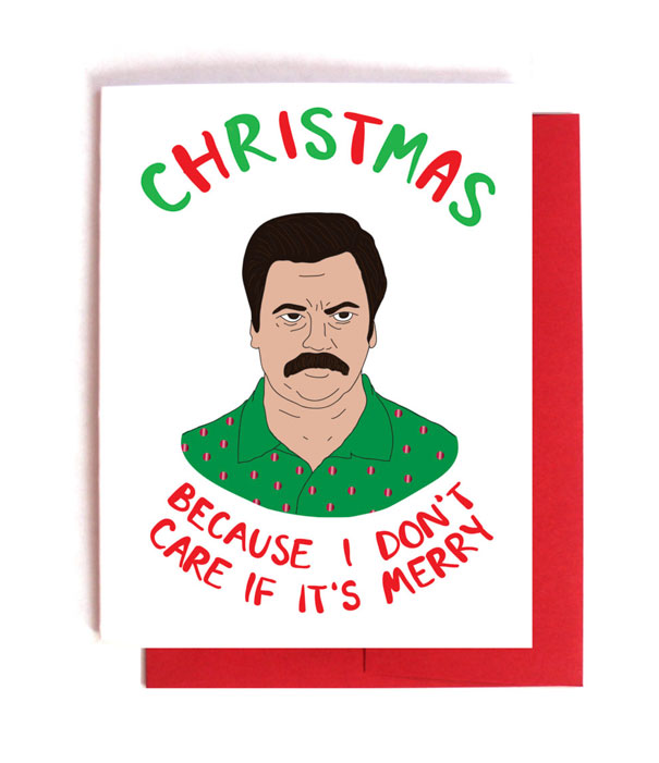 Rude Christmas card with a grumpy man illustration and text, "Because I don't care if it's merry," in festive colors.