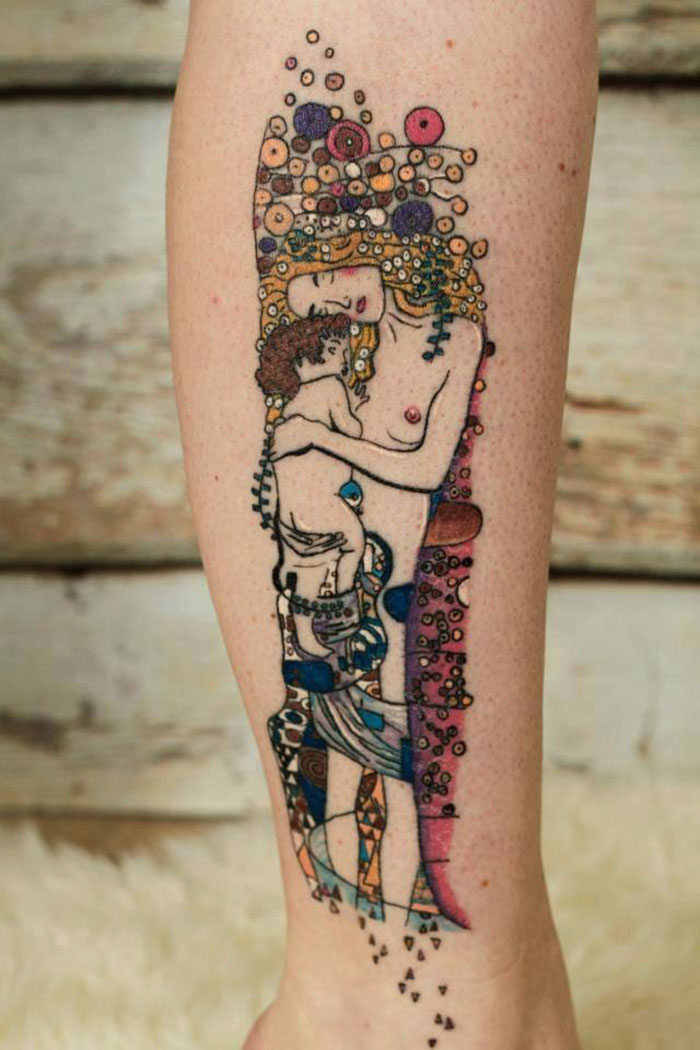 Gustav Klimt tattoo on calf, depicting colorful abstract figures in a detailed artistic style.