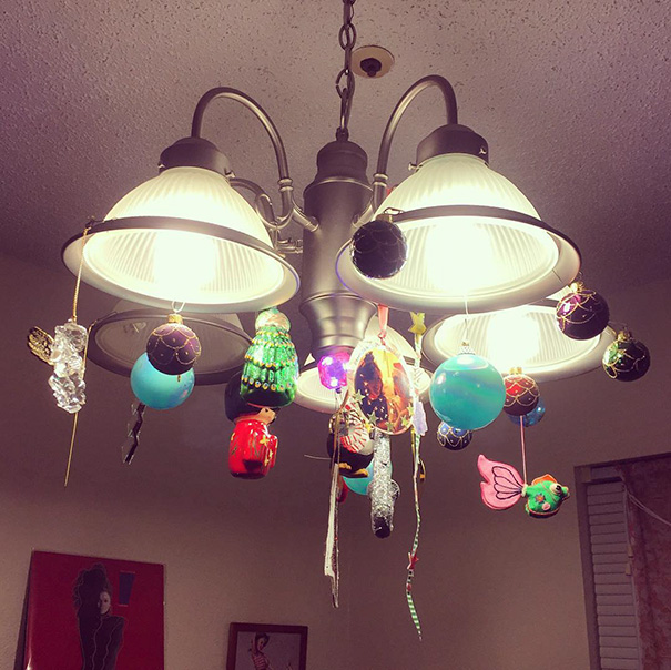 Christmas ornaments hanging from a chandelier, creatively protecting them from cats and dogs.