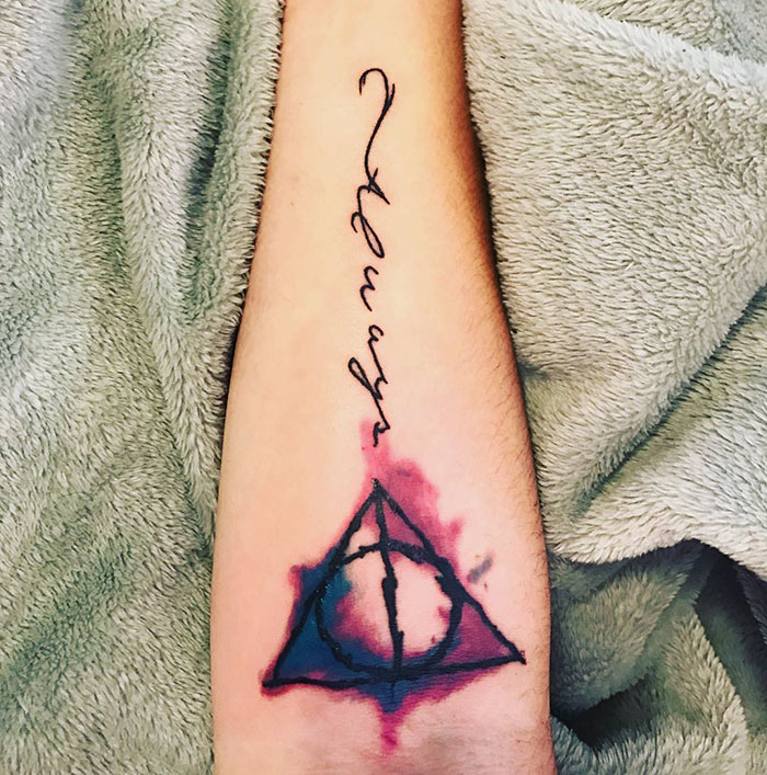 Subtle Harry Potter tattoo featuring "Always" script and Deathly Hallows symbol on arm.