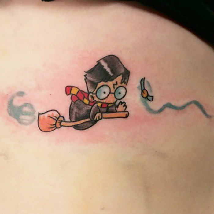 Cartoon Harry Potter tattoo with glasses, broomstick, and Golden Snitch, perfect for Potterheads.