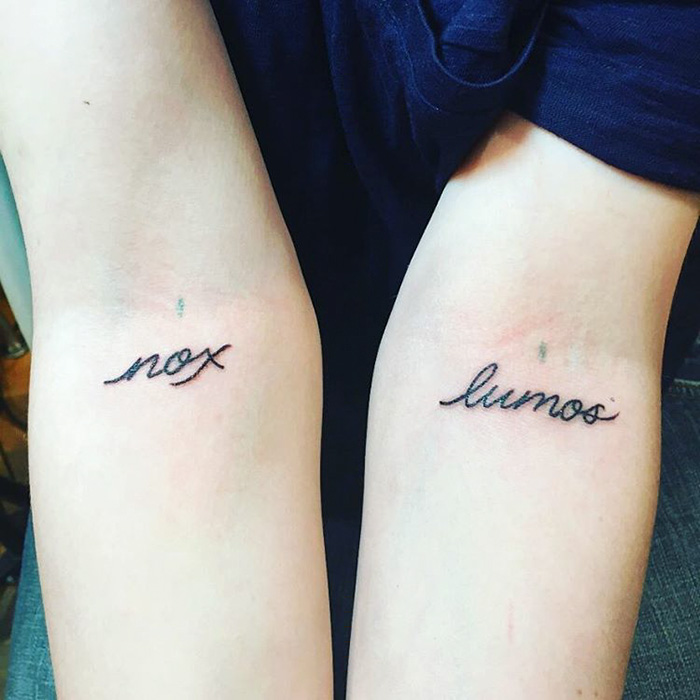 Harry Potter tattoos of the words "nox" and "lumos" inked on forearms in a subtle script.