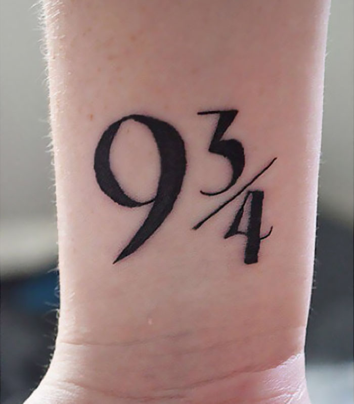 Harry Potter tattoo of platform 9¾ on a wrist, symbolizing the magical journey for true Potterheads.
