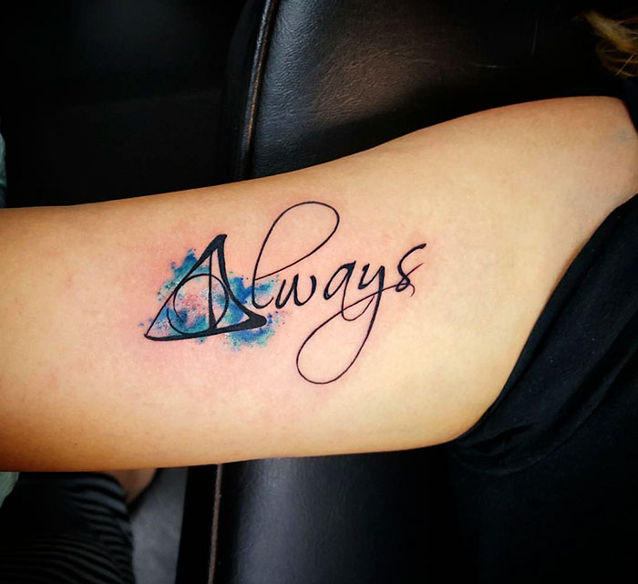 Minimalist Harry Potter tattoo featuring the word "Always" with a subtle Deathly Hallows symbol on the arm.