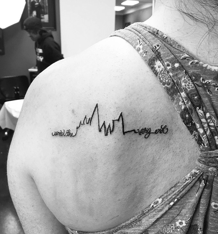 Subtle Harry Potter tattoo on a shoulder in cursive script, reading "until the very end," referencing a fan-favorite quote.
