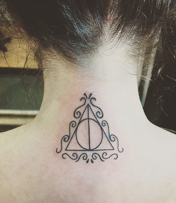 Harry Potter tattoo of Deathly Hallows symbol with ornate design on the neck.
