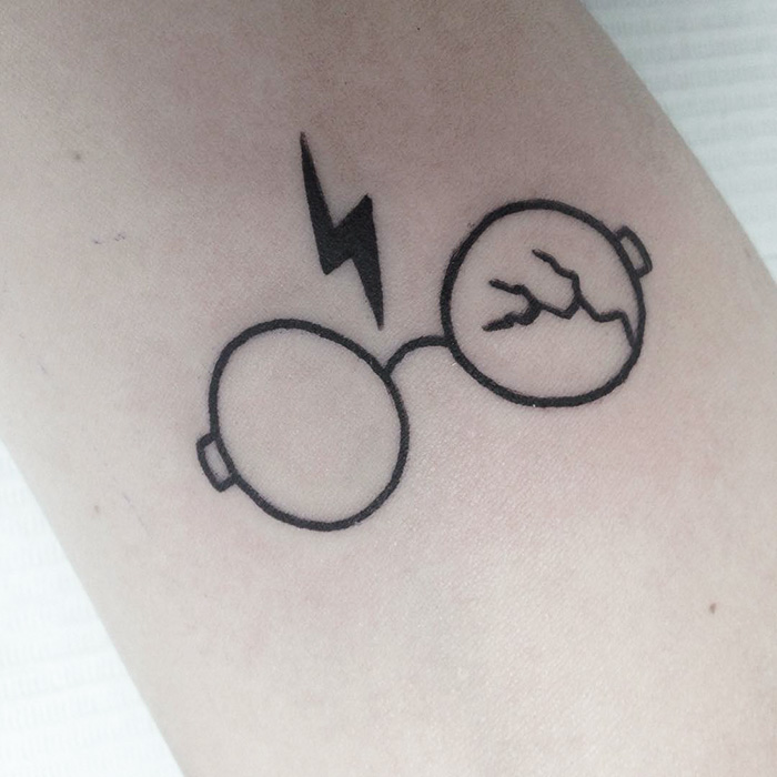 Harry Potter tattoo with glasses and a lightning bolt, symbolizing subtle magic for true fans.