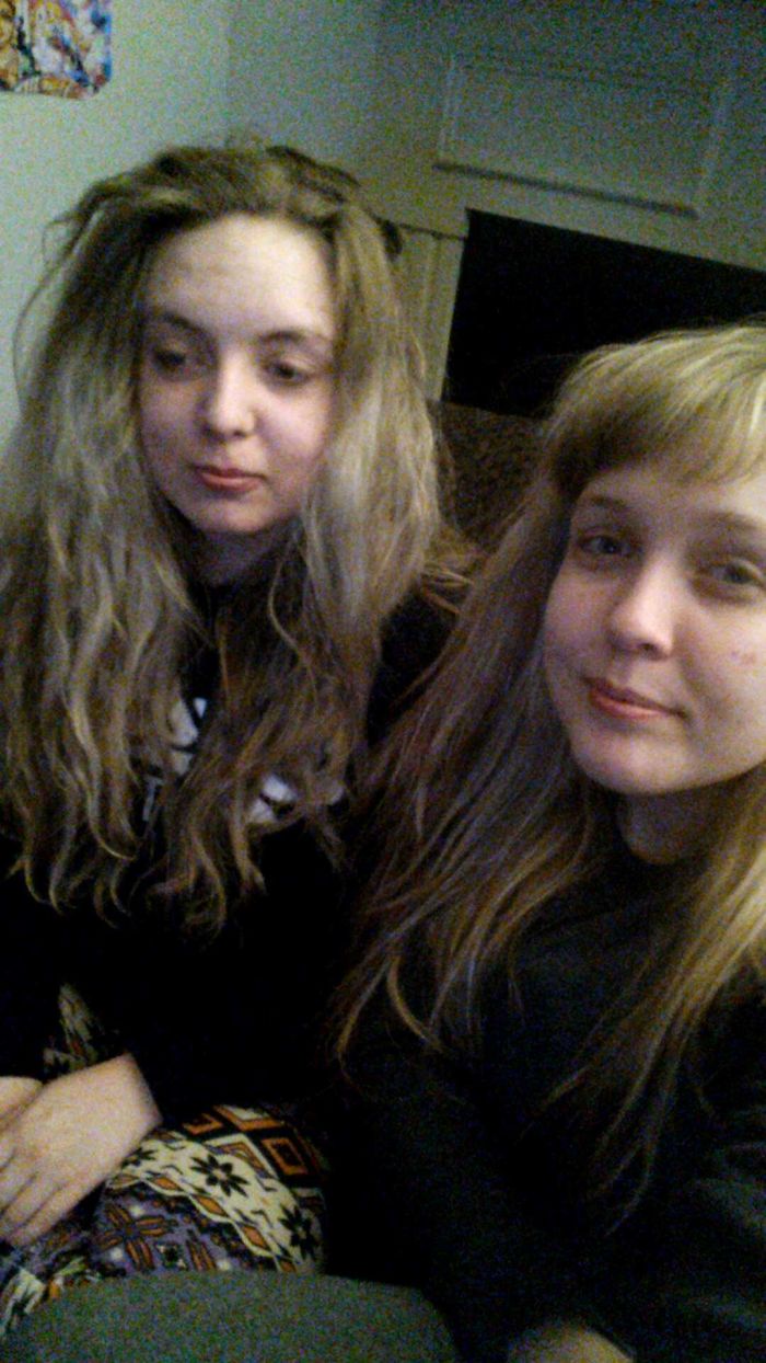 Two doppelgangers sitting on the sofa 