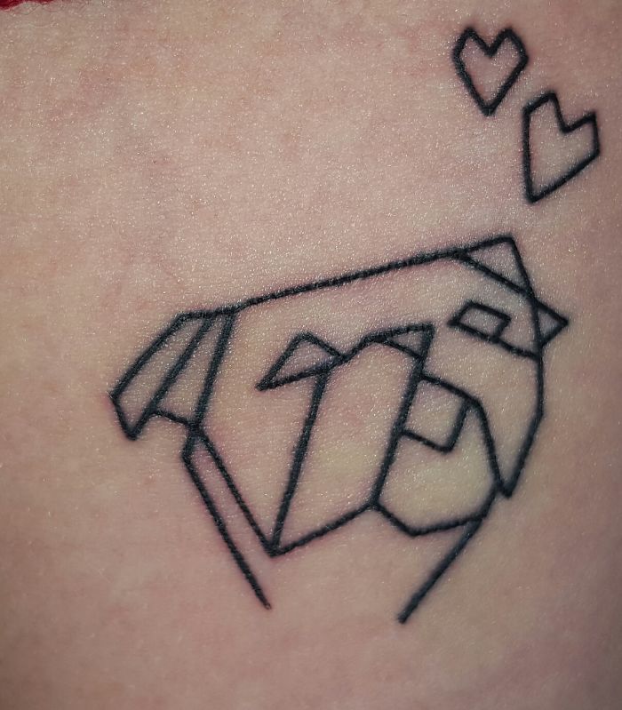 Geometric dog tattoo with hearts, showcasing a creative dog tattoo idea.