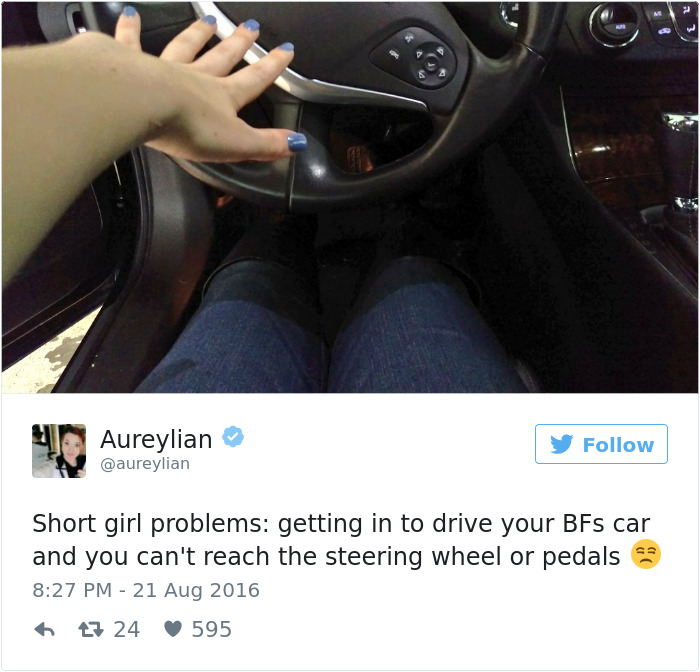 Short people problems: person in car struggling to reach the steering wheel and pedals, highlighting the challenge of being short.