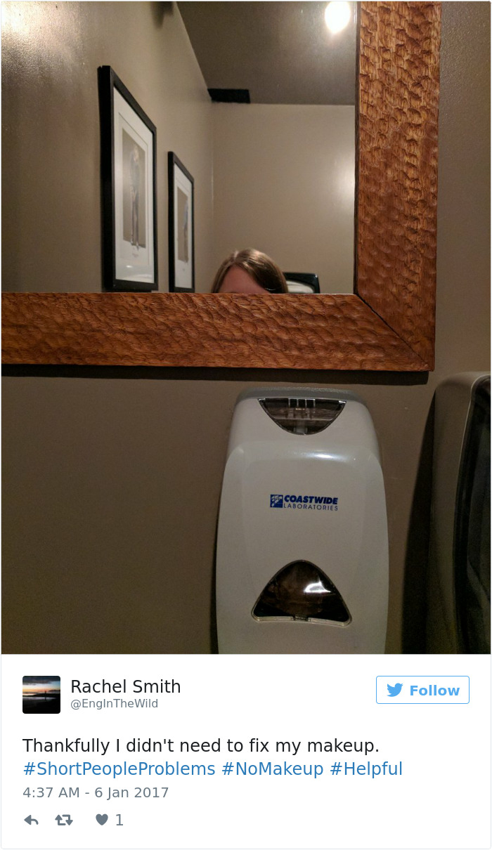 Person's head barely visible below mirror in bathroom, illustrating short people problems.