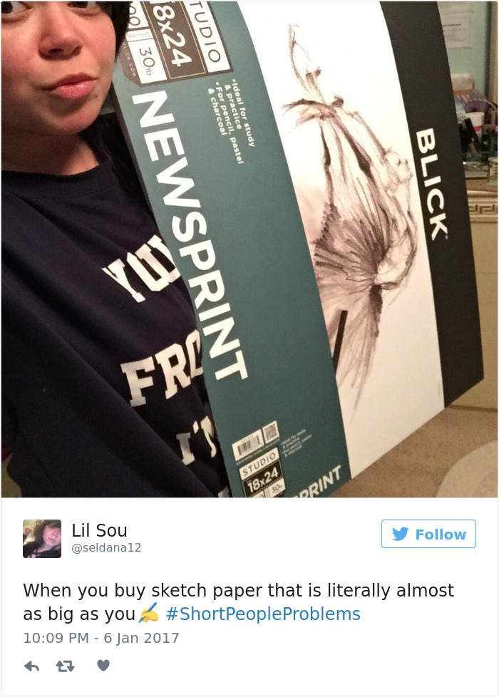 Person holding large sketch paper, capturing the humor of short people problems.