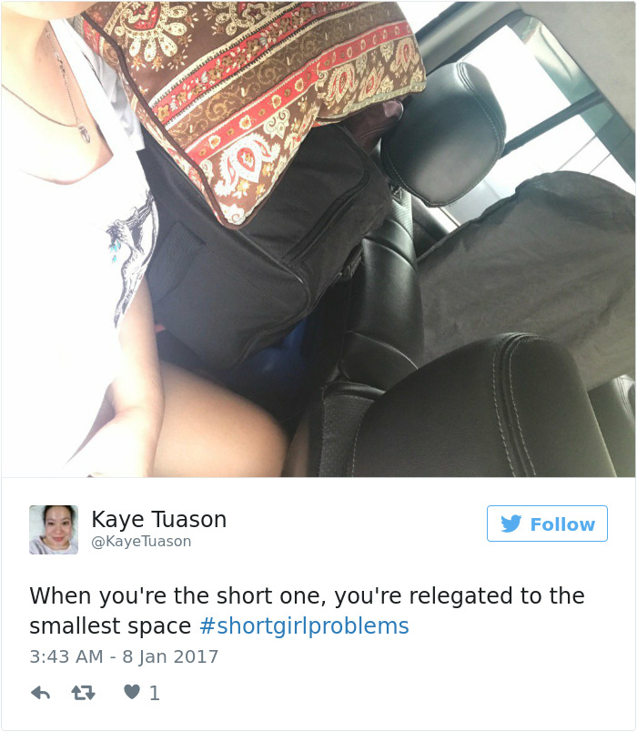Short girl problems: a woman squeezed in a car surrounded by bags, illustrating the struggle for space for short people.