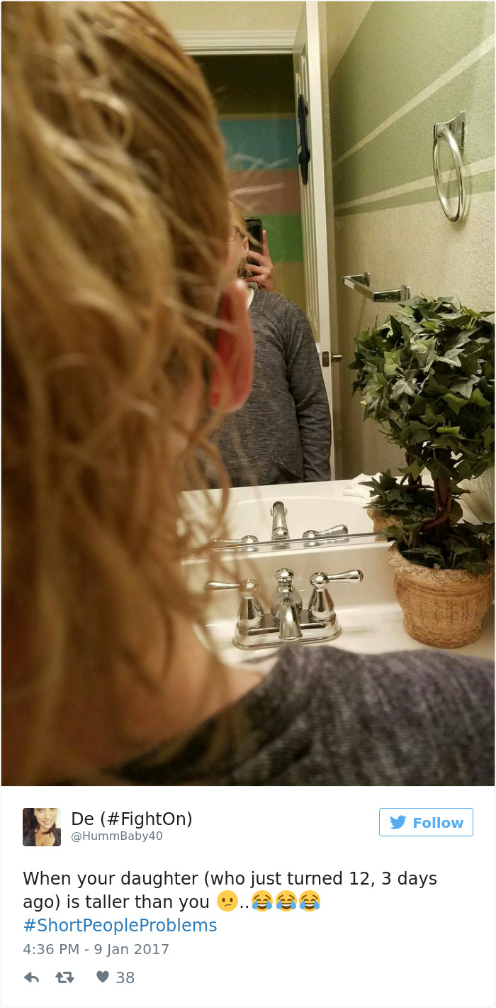 Person taking a mirror selfie with text overlay about short people problems and daughter being taller.
