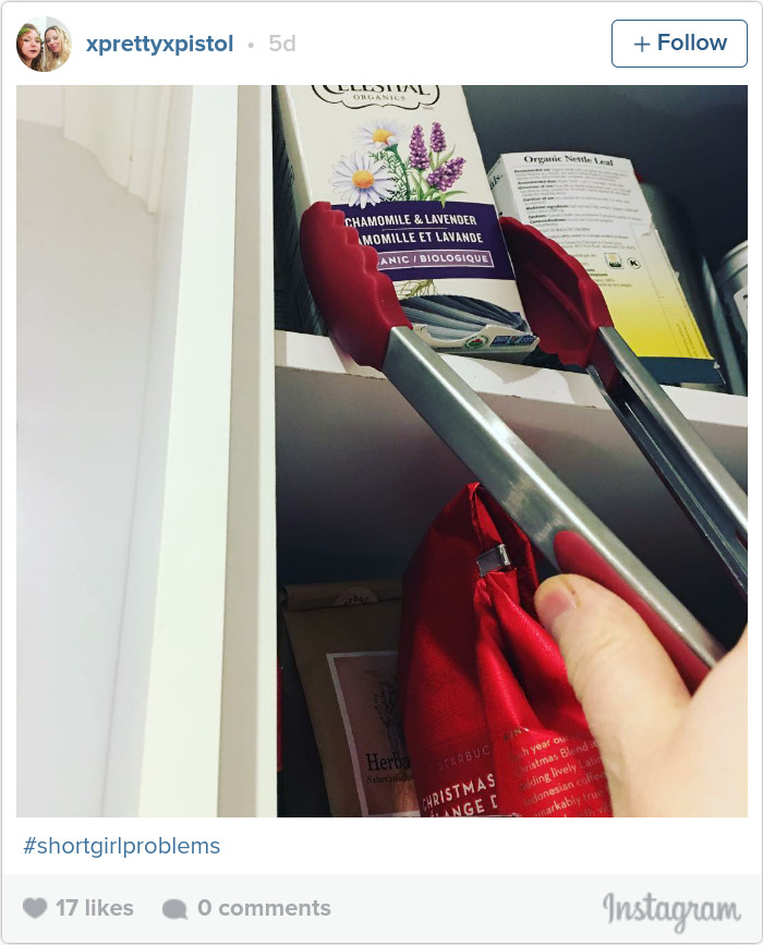 Using kitchen tongs to reach tea on a high shelf, highlighting short people problems.