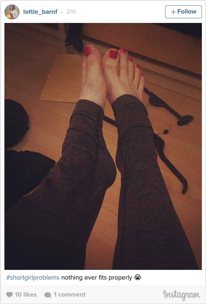 Feet in long leggings with fabric folds; a humorous take on short people problems.