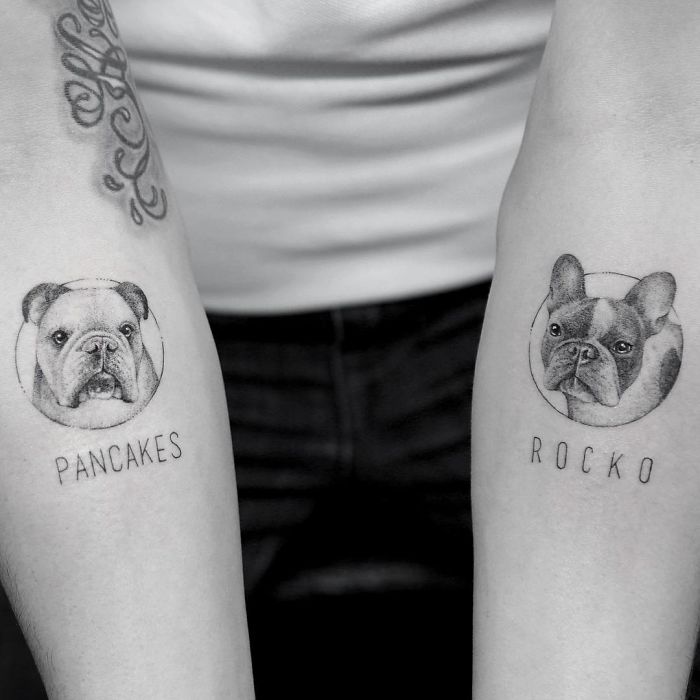 Dog tattoos on forearms featuring portraits of Bulldogs named Pancakes and Rocko.
