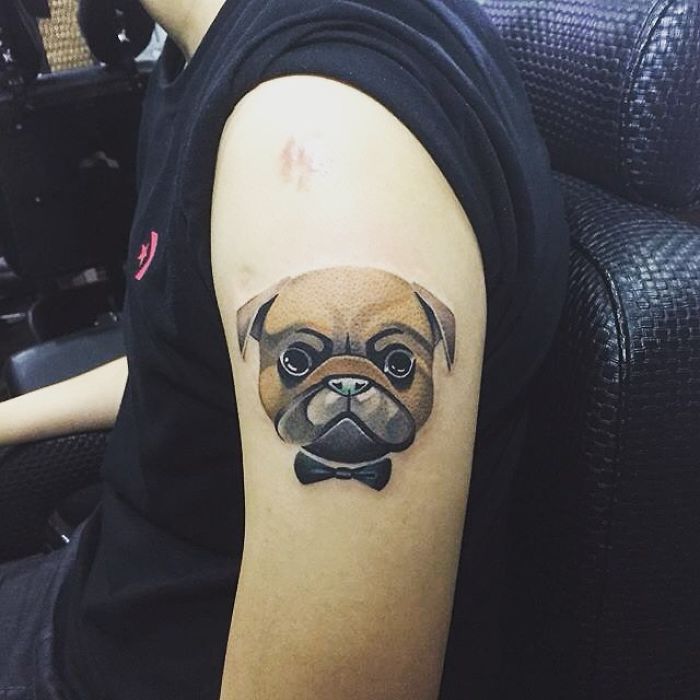 Arm tattoo featuring a dog with a bow tie, showcasing a unique dog tattoo idea.