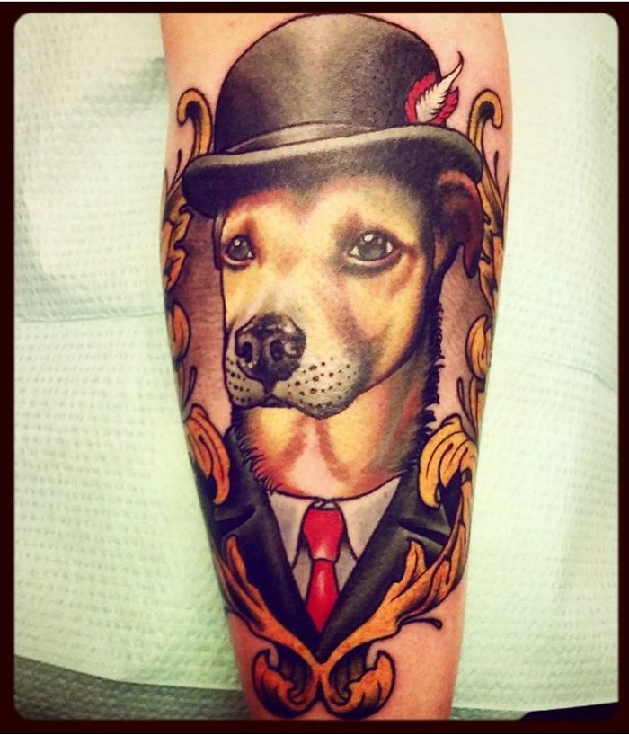 Tattoo of a dog in a suit and hat, exemplifying creative dog tattoo ideas.