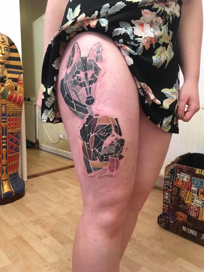 Geometric dog tattoo design on a person's thigh, depicting creative canine art.