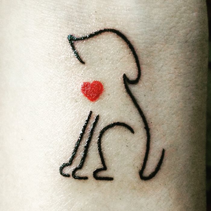 Minimalist dog tattoo design with red heart accent.
