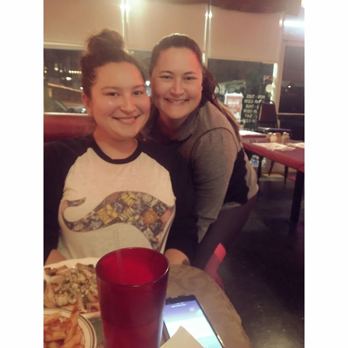 Two doppelgangers sitting in a restaurant 