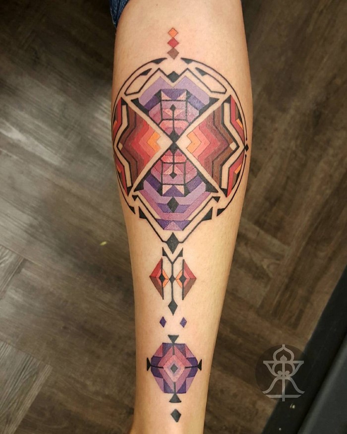 Amazonian tribal art-inspired tattoo in geometric patterns by Brian Gomes on arm.