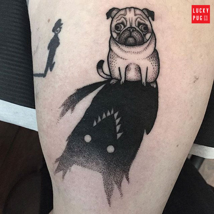 Creative dog tattoo featuring a pug with a shadow of a monster on skin.
