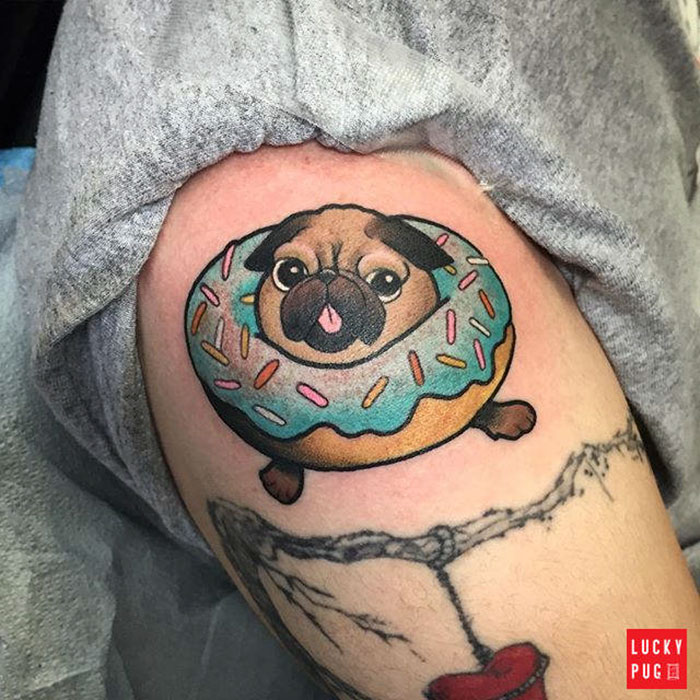 Pug tattoo design with a donut collar, featuring colorful sprinkles.