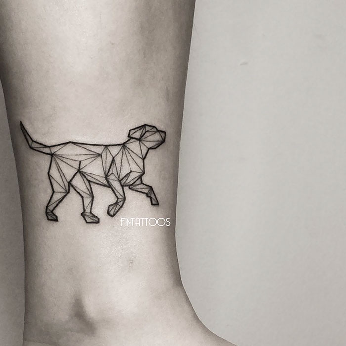 Geometric dog tattoo design on leg, featuring angular lines and minimalist style.