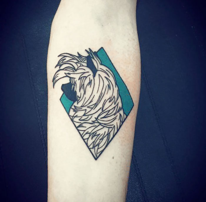 Geometric dog tattoo featuring stylized fur on a forearm.