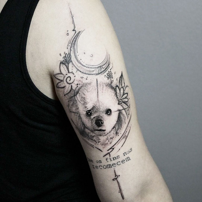 Dog tattoo design featuring a detailed dog portrait with floral and celestial elements on the upper arm.