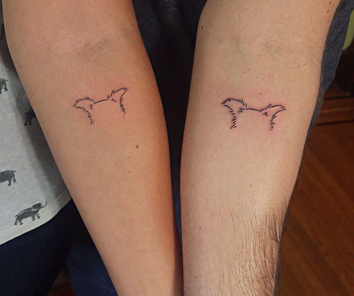 Matching minimalist dog tattoos on two forearms, emphasizing best dog tattoo ideas.