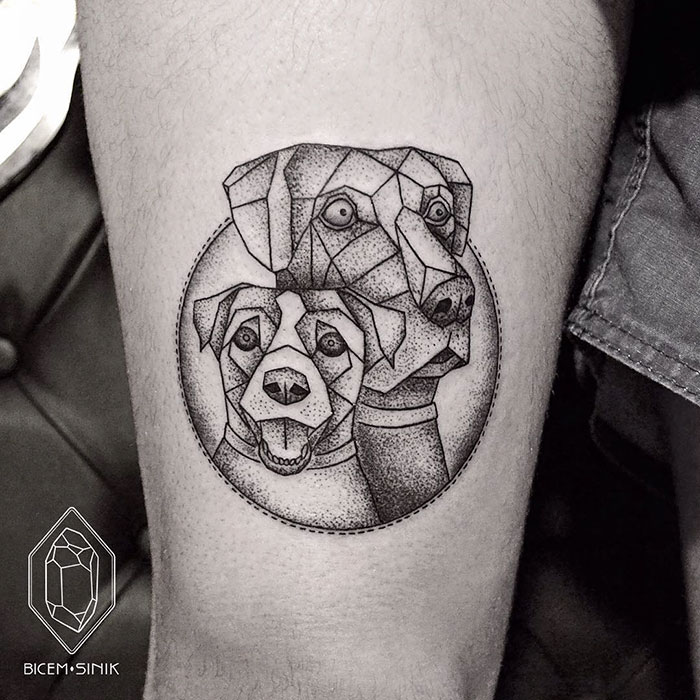 Geometric dog tattoo design featuring two stylized dogs in black ink.