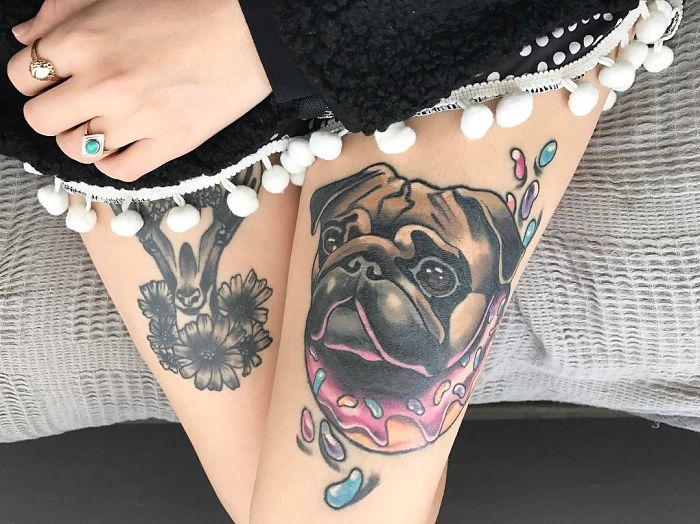 Colorful dog tattoo featuring a pug design on a person's leg, capturing unique ink art.