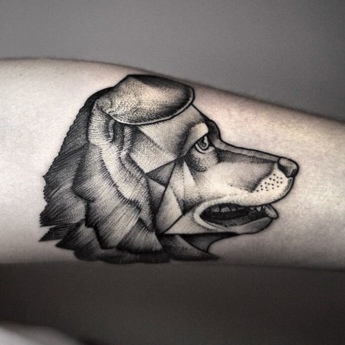 Geometric dog tattoo on forearm, showcasing intricate shading and design, perfect for dog tattoo ideas inspiration.