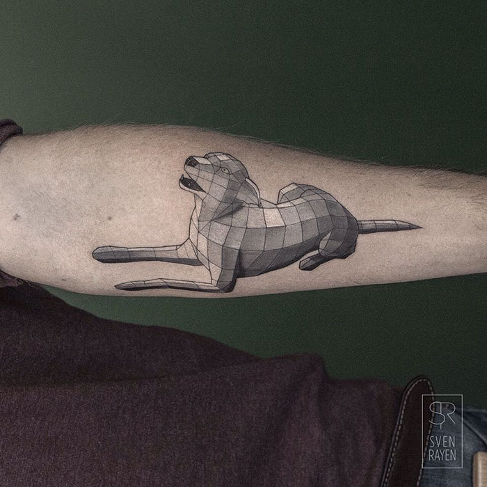 Geometric dog tattoo on forearm, showcasing artistic dog designs.