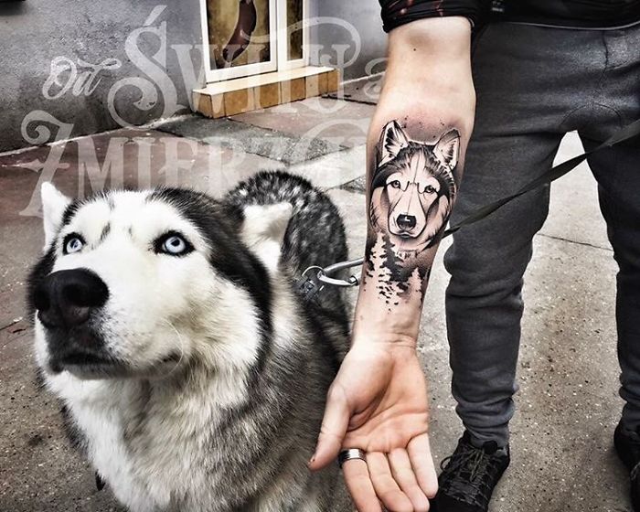 Dog tattoo idea with a realistic husky design on a person's forearm, matching the husky on a leash.