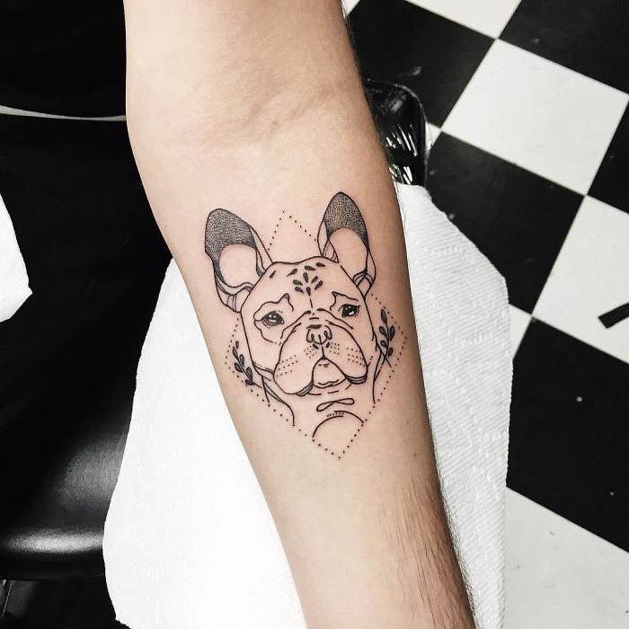 Black and white tattoo of a French bulldog on an arm, showcasing intricate dog tattoo design.