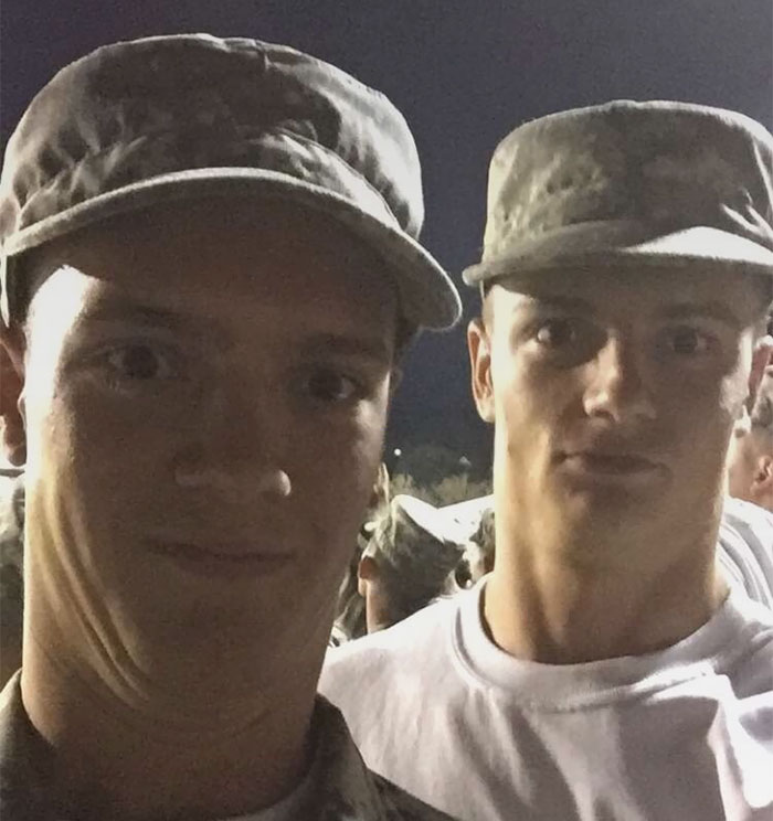 Two doppelgangers taking a selfie in an army workout 