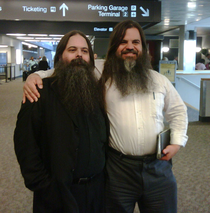 Two doppelgangers hugging at the airport 