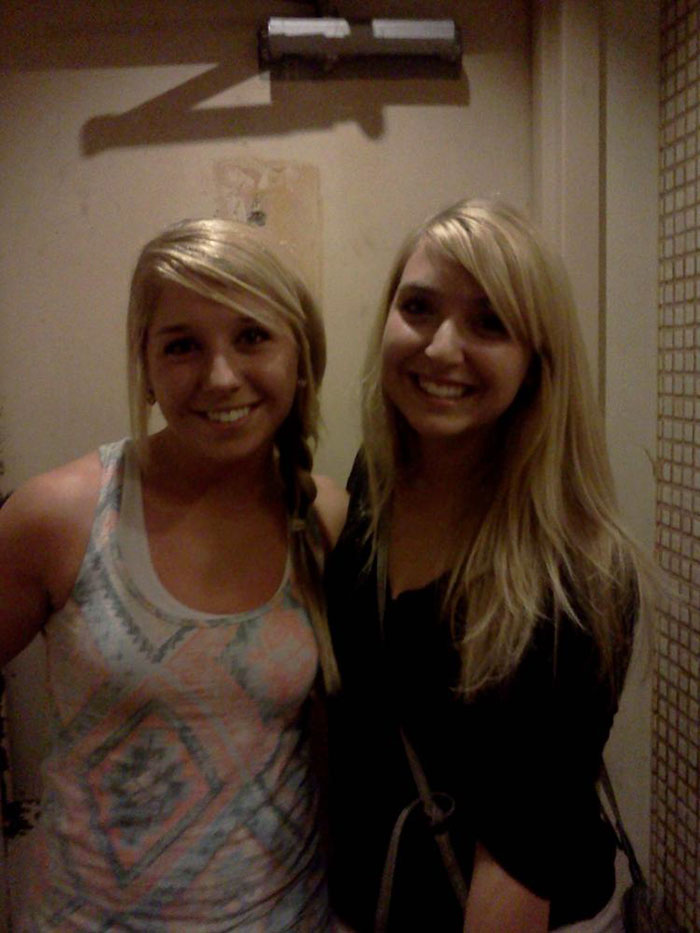 Two doppelgangers posing near a door 