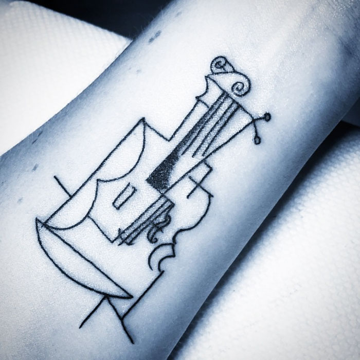 Abstract line tattoo inspired by classical art on forearm, featuring a geometric violin design.